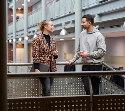 Twee docenten overleggen op de gang